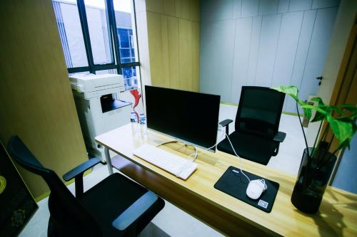 an office with a desk with a computer on it at Ramada by Wyndham Vientiane Central in Vientiane