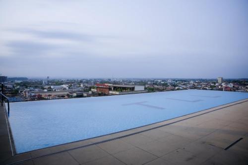 a large swimming pool on the roof of a building at Ramada by Wyndham Vientiane Central in Vientiane