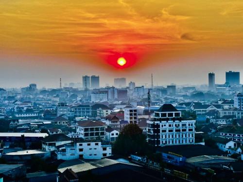 a view of a city with the sun in the sky at Ramada by Wyndham Vientiane Central in Vientiane