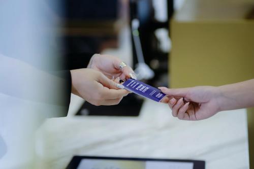 a person holding a purple item in their hand at Ramada by Wyndham Vientiane Central in Vientiane