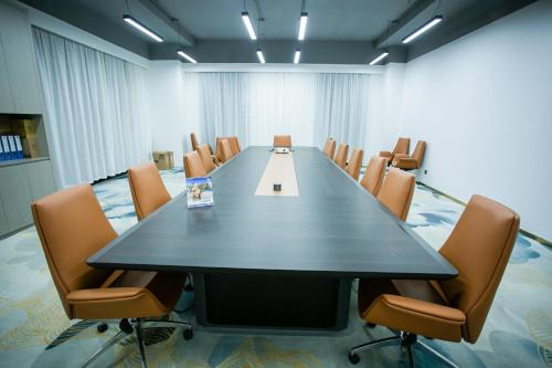 a conference room with a long table and chairs at Ramada by Wyndham Vientiane Central in Vientiane