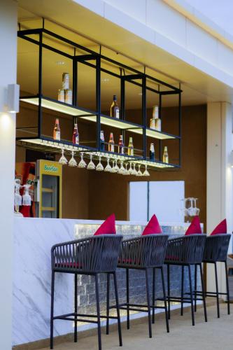 a group of chairs and a table with pink pillows at Ramada by Wyndham Vientiane Central in Vientiane