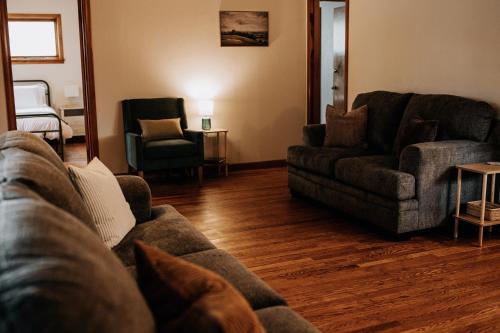 a living room with a couch and two chairs at The Mueller Haus in Hermann