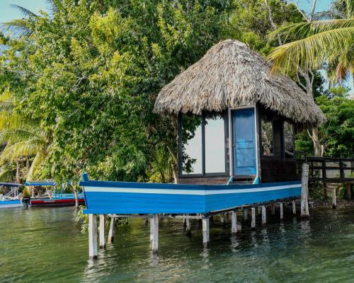 a small house on a dock in the water at Mayan Spirit in Flores