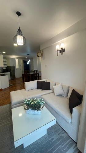 a living room with a couch and a table at THE WIND LILY - Lake View Luxury Apartment in Nuwara Eliya