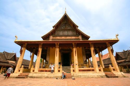a group of people standing in front of a building at Ramada by Wyndham Vientiane Central in Vientiane