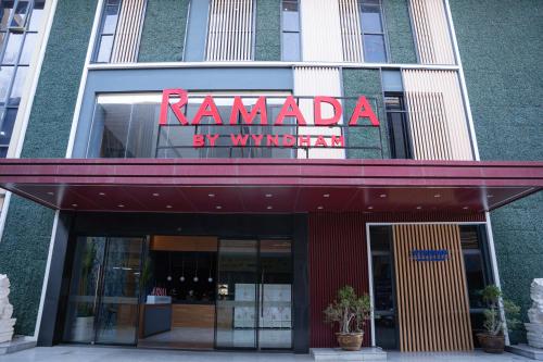 a building with a sign that reads ramadi by myowment at Ramada by Wyndham Vientiane Central in Vientiane