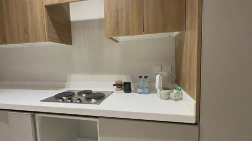 a kitchen with a stove top oven in a kitchen at Lovely Residence in Al Khobar