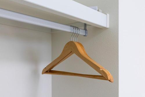 a wooden hanger on a shelf in a room at Amp flat HEC 02 in Muromimachi