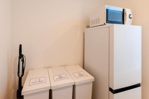 a white refrigerator with three boxes next to it at Amp flat HEC 02 in Muromimachi