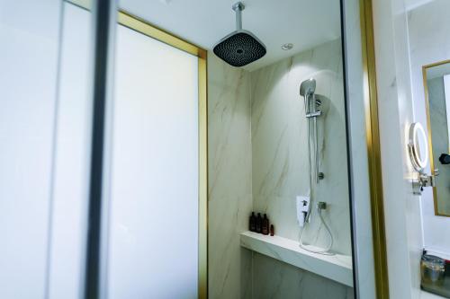 a bathroom with a shower and a sink at Ramada by Wyndham Vientiane Central in Vientiane