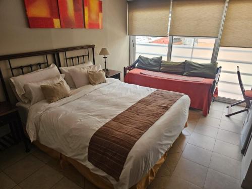 a bedroom with a large bed and a window at Departamento Caseros Centro in Salta