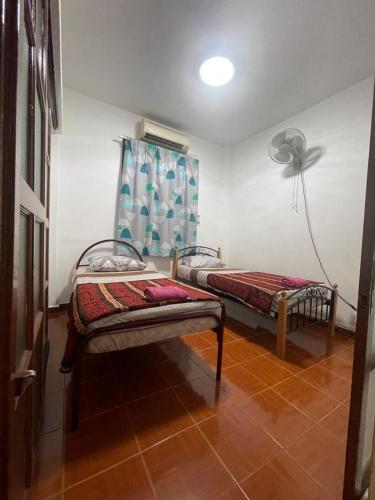 Ένα ή περισσότερα κρεβάτια σε δωμάτιο στο PD Perdana Homestay 3BR