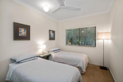 a bedroom with two beds and a window at Beautiful Palm Beach in Gold Coast