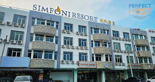 a hotel with a sign on the front of it at Triima Inn Dayang Bay by Perfect Host in Kuah