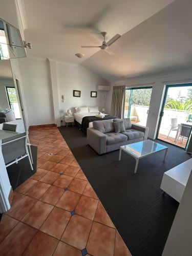 a living room with a couch and a table at Aruba Beach Resort in Gold Coast
