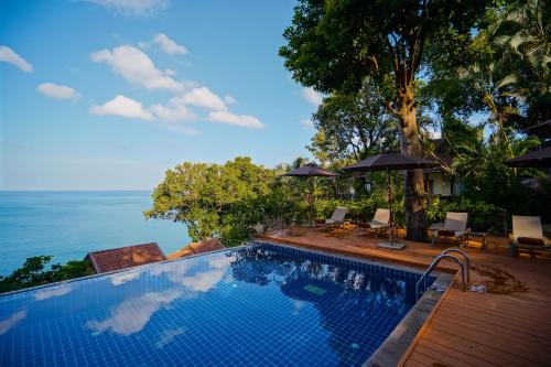 a swimming pool with a view of the ocean at Anona Sunset Boutique in Karon Beach