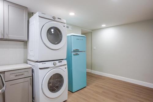 a kitchen with a washing machine and a blue refrigerator at Stylish Stay in Center City, French-Japanese & Minimalist Vibes in Philadelphia