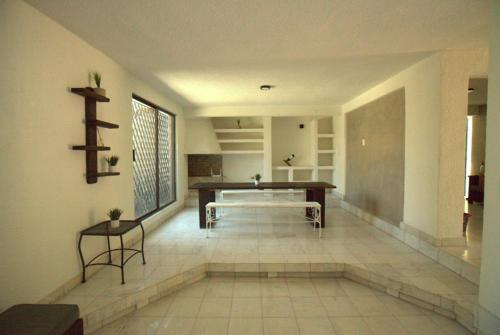a living room with a table in a room at Casa La Embajada in La Paz