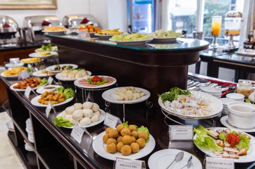 a buffet line with plates of food on display at A25 Hotel - 15 Trần Quốc Toản in Hanoi