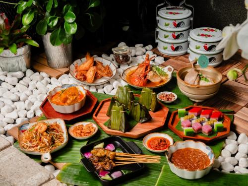 a table with various dishes of food on it at Copthorne King's Hotel Singapore in Singapore