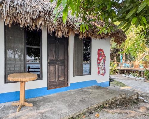 a stool in front of a small building at Mayan Spirit in Flores