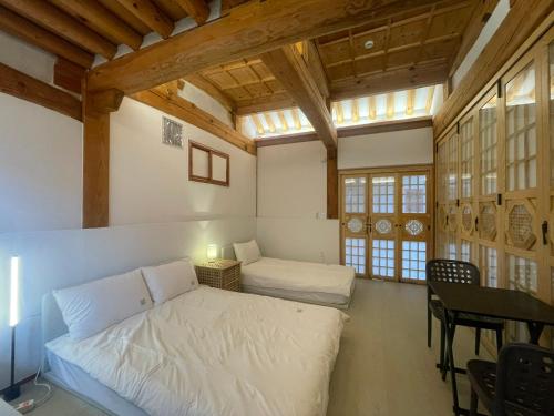 a bedroom with a bed and a table in a room at Stay 148 in Seoul