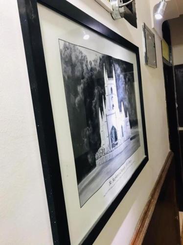 a picture of a picture of a castle on a wall at Hotel mystique inn in Ooty