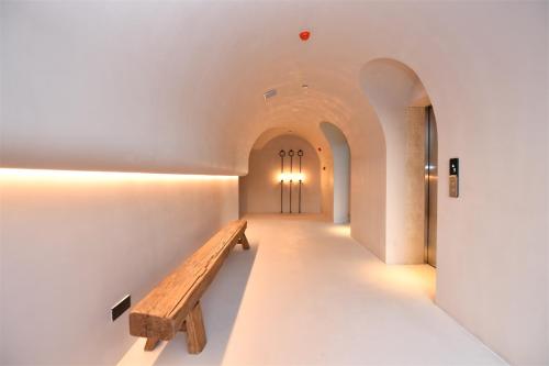 a hallway with a wooden bench in a building at Shanheli wabi Sabi Natural Wind Hotel Chenghai Branch in Shantou