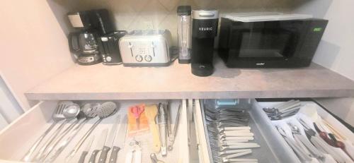 a refrigerator filled with utensils and a coffee maker at Cozy Home Close to Attractions in Niagara Falls in Thorold