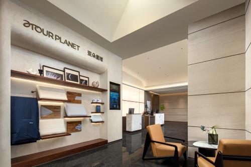 a lobby of a hotel with a table and chairs at Atour Hotel Hangzhou Cainiao Headquarter Fengxin Road in Hangzhou