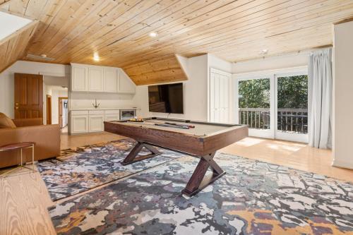 a living room with a pool table in it at Stunning Waterfront Mansion with Pool and Hottub in Mercer Island
