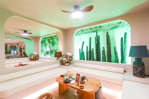 a living room with a white couch and a table at Shanheli wabi Sabi Natural Wind Hotel Chenghai Branch in Shantou