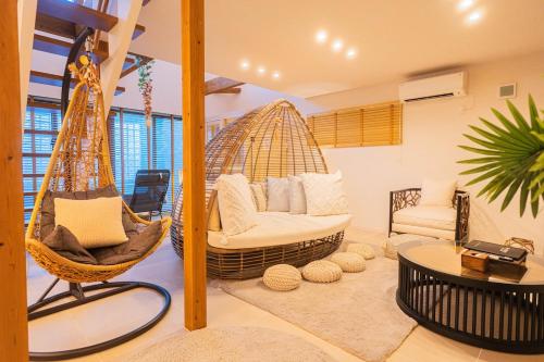 a living room with a hammock in a room at ReVIERA Resort Villa in Chatan