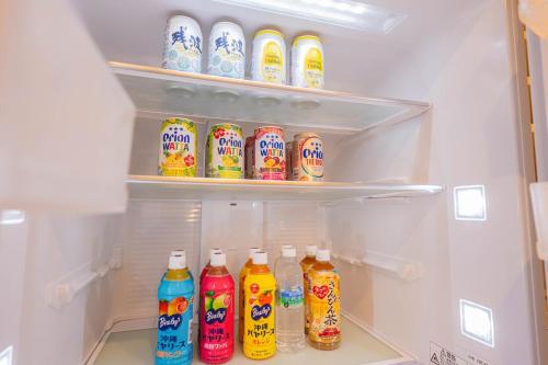 a refrigerator filled with lots of bottles of drinks at ReVIERA Resort Villa in Chatan