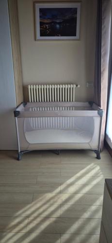 a white bench sitting in a room with a window at La Mansarda sul lago in Bellano