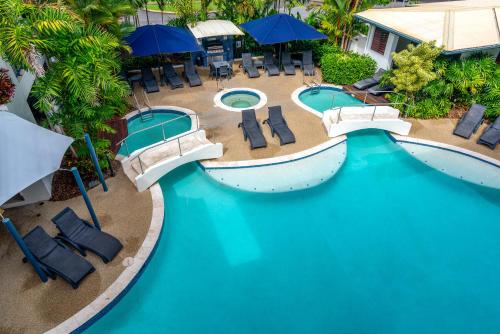 an overhead view of a pool with chairs and umbrellas at Meridian at Port Douglas - Adults Only in Port Douglas