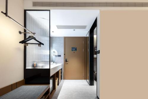 a bathroom with a sink and a mirror at Atour Hotel Hangzhou Cainiao Headquarter Fengxin Road in Hangzhou