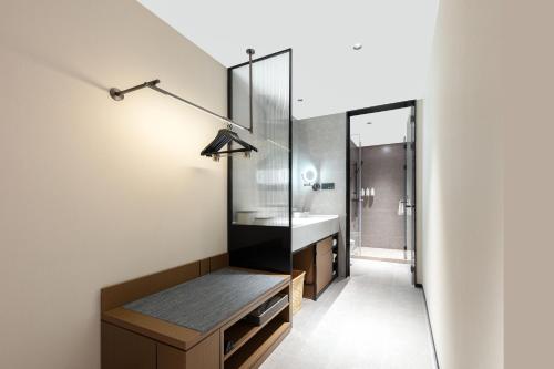 a bathroom with a sink and a mirror at Atour Hotel Hangzhou Cainiao Headquarter Fengxin Road in Hangzhou