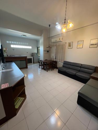 a living room with a couch and a table at Muang Thong Family Suite Hatyai in Hat Yai