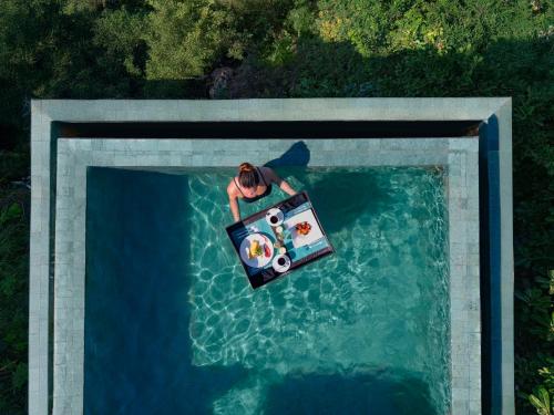 an overhead view of a person in a boat in the water at Banyan Tree Cabo Marques in Acapulco
