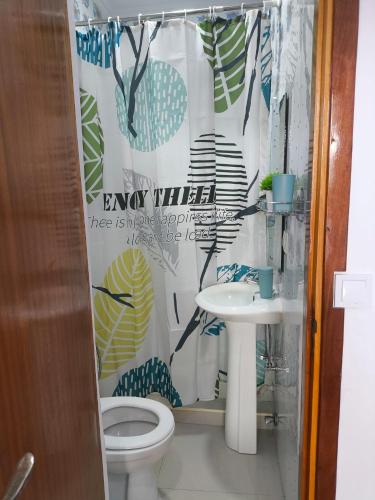 a bathroom with a toilet and a sink at Old Town view Apartment in Cidade Velha