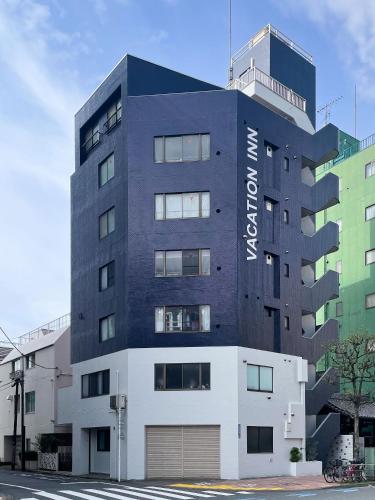 a black building with a sign on it at Vacation Inn Omorikaigan 1 in Tokyo