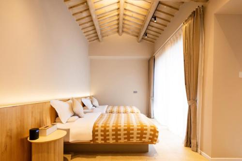 a bedroom with a bed and a large window at Lijiang Jinghua Inn in Lijiang