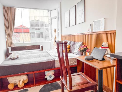 a bedroom with a bed and a desk with a laptop at La Casa Di Dicembre 18 Hàng Cháo in Hanoi