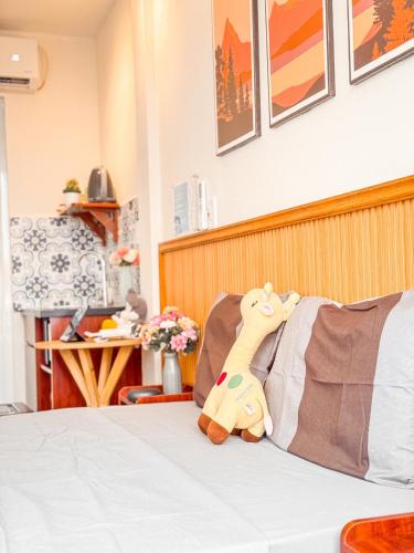 a stuffed animal sitting on top of a bed at La Casa Di Dicembre 18 Hàng Cháo in Hanoi