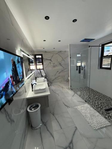 a large bathroom with a sink and a shower at White Sky Beach Villas in Culloden