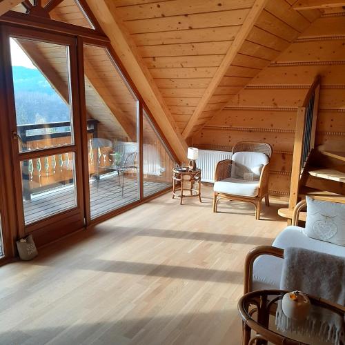 a living room with large windows and a wooden ceiling at Villa of Roses in Lanckorona
