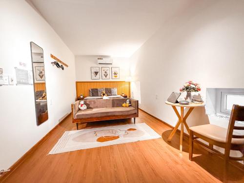 a bedroom with a bed and a table and a chair at La Casa Di Dicembre 18 Hàng Cháo in Hanoi