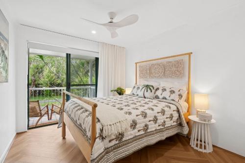 a bedroom with a bed and a window at The Nines Noosa in Noosaville
